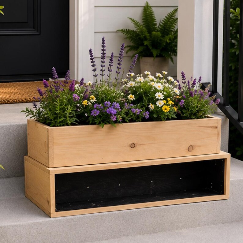 May include: A two-tiered wooden planter box filled with a variety of colorful flowers, including lavender, daisies, and other blooms. The planter is made of light-colored wood and sits on a concrete step. The lower tier is open, creating a storage space.