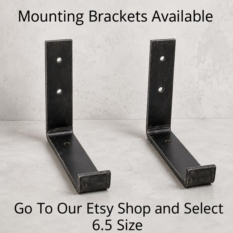 May include: Two black metal mounting brackets with a 6.5-inch size, each featuring a right-angle design with pre-drilled holes for easy installation. The text "Mounting Brackets Available" and "Go To Our Etsy Shop and Select 6.5 Size" are visible.