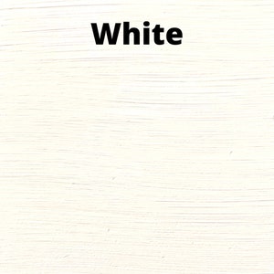 May include: A close-up of a white painted surface with a brushstroke texture. The word "White" is written in black text at the top of the image.