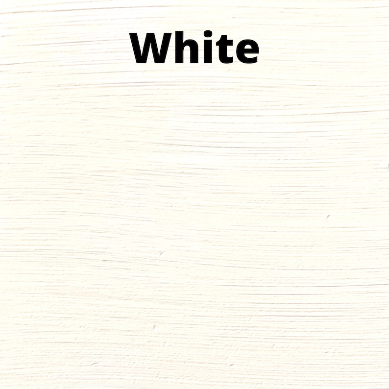 May include: A close-up of a white painted surface with a brushstroke texture. The word "White" is written in black text at the top of the image.