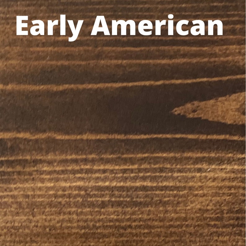 May include: Close-up of a wood grain texture in a dark brown color. The wood has a smooth finish and a consistent grain pattern. The text "Early American" is visible at the top of the image.