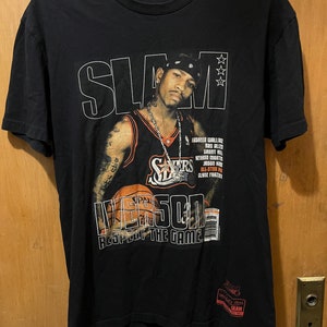 May include: Black t-shirt with a graphic of Allen Iverson in a Philadelphia 76ers jersey, holding a basketball. The text "SLAM" and "Iverson Respect the Game" are printed on the shirt.