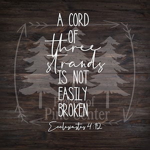 May include: A wood sign with a white background and black text. The text reads "A cord of three strands is not easily broken. Ecclesiastes 4:12". The sign is surrounded by a white outline of two pine trees.