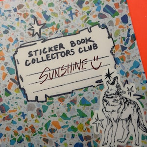 May include: A rectangular sticker featuring a terrazzo pattern background with multicolored flecks. The text reads STICKER BOOK COLLECTORS CLUB and SUNSHINE with a smiley face. A separate sticker shows a black and white line drawing of a howling wolf.