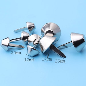 May include: Assortment of silver metal cone-shaped nailheads with different sizes, including 12mm, 17mm, 20mm, and 25mm.