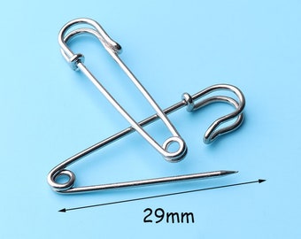 May include: A silver safety pin with a 29mm length. The pin is open and the point is visible.