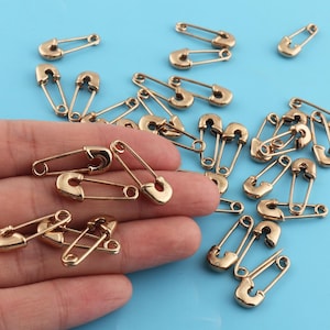 Metal brooch resembling safety pin online