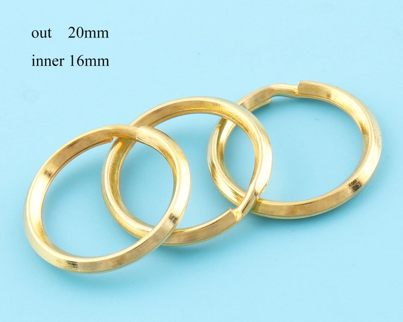 May include: Three gold-colored key rings, each with an outer diameter of 0.79 inches and an inner diameter of 0.63 inches, are interlocked. The key rings are displayed against a light blue background.