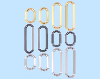 May include: Assortment of oval-shaped metal rings in gold, silver, and black finishes. The rings are of varying sizes.