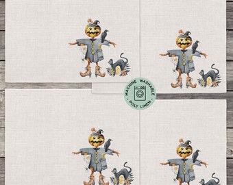 May include: Set of four linen placemats featuring a watercolor illustration of a scarecrow with a pumpkin head, wearing a witch's hat, holding a broom, and surrounded by crows and black cats. The placemats are machine washable and made of poly linen.