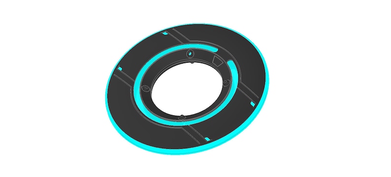 May include: A black circular disc with a blue neon ring around the edge. The disc has a smaller circular hole in the center.