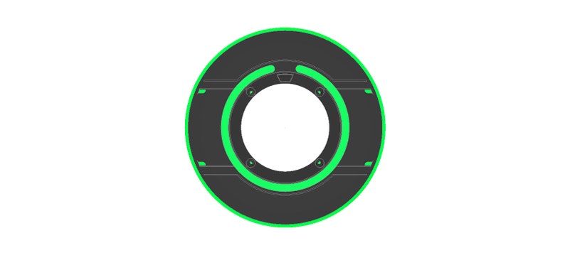 May include: A black and green circular object with a ring of green light around the center hole. The object has a textured surface and a small black ring around the center hole.