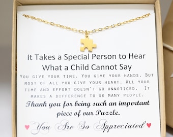 May include: A gold necklace with a puzzle piece charm and a card that reads "It Takes a Special Person to Hear What a Child Cannot Say. You give your time. You give your hands. But most of all you give your heart. All your time and effort doesn't go unnoticed. It makes a difference to so many people. Thank you for being such an important piece of our Puzzle. You Are So Appreciated."