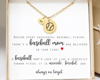 May include: A gold-colored baseball necklace with a heart-shaped charm with the number 44 and a round charm with a baseball design. The necklace is presented in a gift box with text that reads "Behind every successful baseball player, there's a baseball mom."