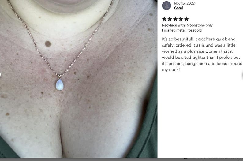 May include: A silver chain necklace with a teardrop-shaped moonstone pendant. The necklace is worn by a person with a larger chest size. The necklace is described as being perfect and hangs nicely around the neck.