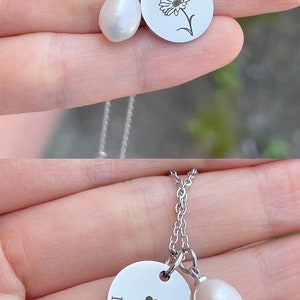 May include: Two silver necklaces with a pearl charm and a silver disc charm. The first necklace has a flower design on the disc charm. The second necklace has the words "I LOVE YOU" and a small heart on the disc charm.