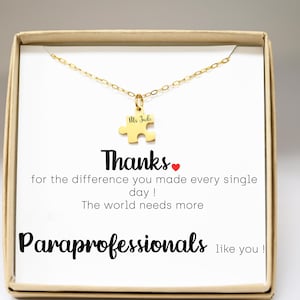 May include: A gold necklace with a puzzle piece pendant that says "Ms Jade" on it. The necklace is in a box with a card that says "Thanks for the difference you made every single day! The world needs more Paraprofessionals like you!"
