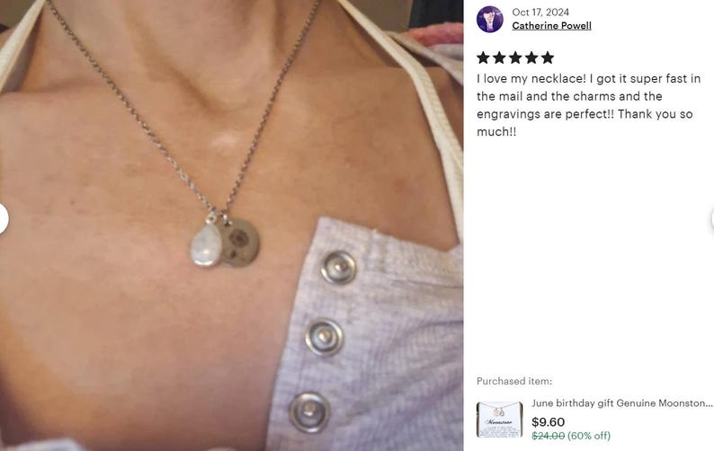 May include: A silver necklace with two charms, one round and one teardrop-shaped, hanging from it. The necklace is worn by a person with a light gray shirt. The text in the image reads: "I love my necklace! I got it super fast in the mail and the charms and the engravings are perfect!! Thank you so much!!"
