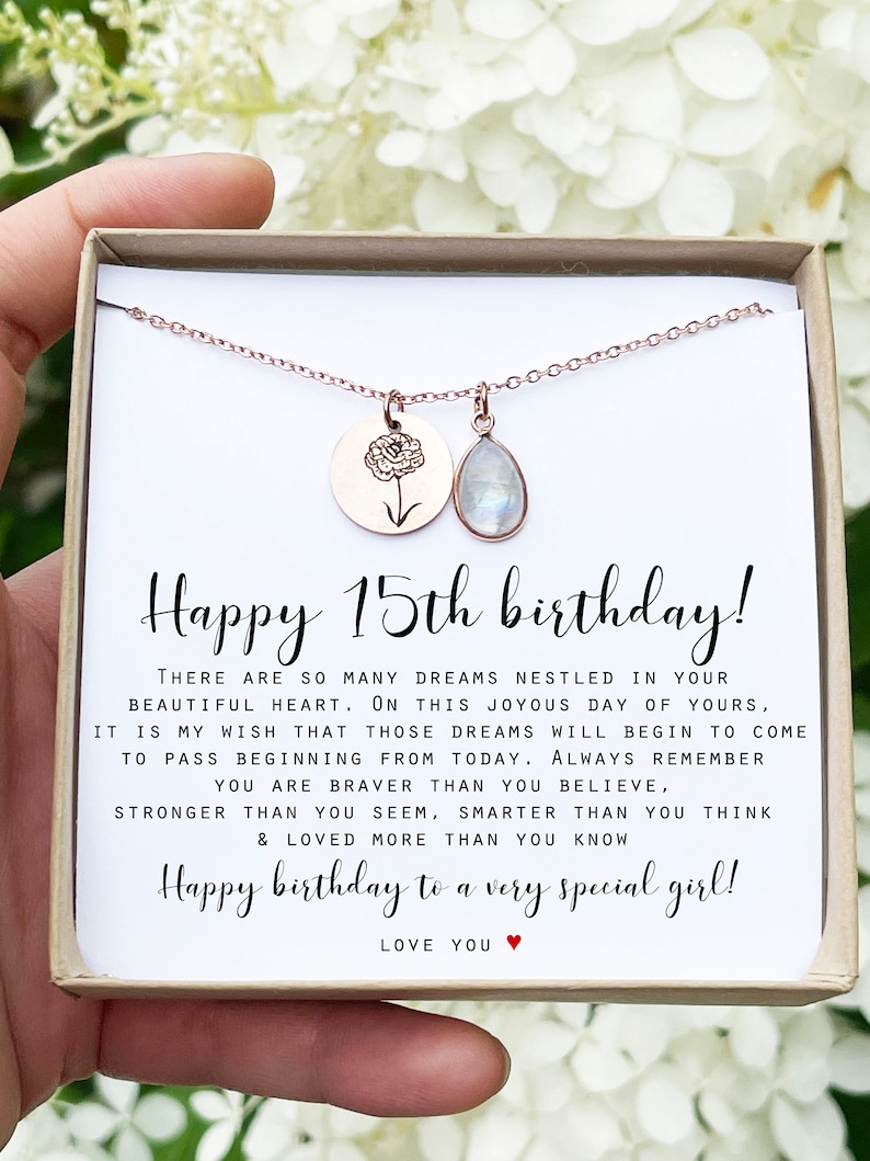 May include: A white card with a rose gold necklace in a box. The card reads "Happy 15th birthday! There are so many dreams nestled in your beautiful heart. On this joyous day of yours, it is my wish that those dreams will begin to come to pass beginning from today. Always remember you are braver than you believe, stronger than you seem, smarter than you think & loved more than you know. Happy birthday to a very special girl! Love you."