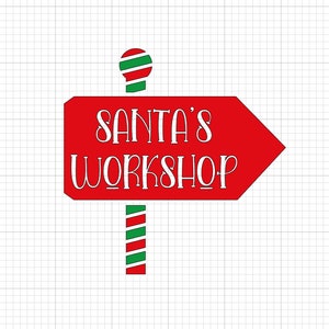 May include: Red and white arrow sign with the text "SANTA'S WORKSHOP" in white. The sign is attached to a red and green striped pole with a red and green striped ball on top.