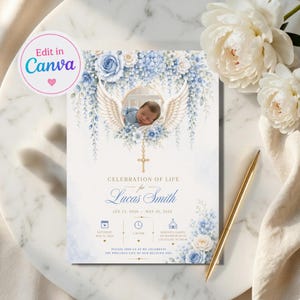 May include: A rectangular celebration of life invitation card featuring a central circular photo of a baby framed by white angel wings and blue floral arrangements. The text reads Celebration of Life for Lucas Smith, Jan 15, 2026 - May 20, 2026, with event details and a gold cross icon.
