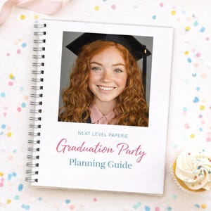 May include: A spiral-bound Graduation Party Planning Guide with a photo of a smiling graduate wearing a cap. The cover features the text "Graduation Party Planning Guide" in pink and teal. A cupcake with white frosting is in the corner.