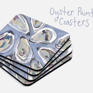 May include: A set of four blue and white coasters with a painted oyster design. The coasters are stacked on top of each other and the text "Oyster Painting Coasters" is written in blue ink above the coasters.