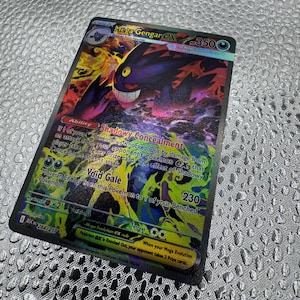 May include: A Mega Gengar EX trading card with 350 HP, featuring a dark purple ghost-like creature with a wide grin. The card displays the Shadowy Concealment ability and Void Gale attack, with colorful, swirling energy graphics and text details.
