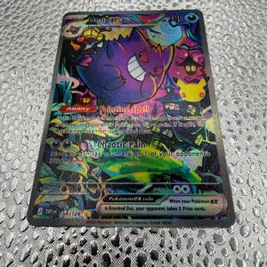 May include: A Gengar ex trading card featuring a vibrant purple Gengar character with a wide grin, set against a dark, colorful background with a yellow Pikachu silhouette, lanterns, and text including Fainting Spell and Chaotic Pain.