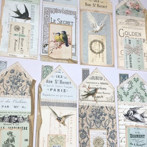 May include: A collection of vintage-style paper ephemera with a variety of designs, including birds, flowers, and text. The paper is in shades of cream, blue, and green. The text includes the words "Le Secret", "Golden", "Diamant", and "163 Rue S! Honor&eacute;".