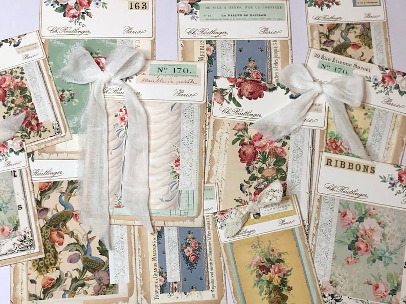 May include: A collection of vintage fabric samples with floral and bird patterns. The samples are tied with white ribbon bows and have text in French. The text includes "Ch. Reutlinger", "Paris", "N&deg; 170", "Meuble en Jouet", "39 Rue Etienne Marcel", "Ribbons", and "Les Magasins sont ouverts de 9 heures du matin a 7 heures du soir".