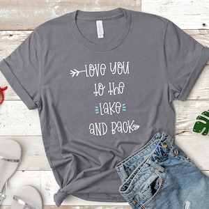 May include: Gray t-shirt with white text that reads "Love you to the lake and back" with an arrow pointing to the left and an arrow pointing to the right.