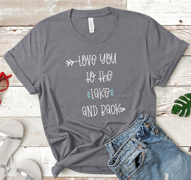 May include: Gray t-shirt with white text that reads "Love you to the lake and back" with an arrow pointing to the left and an arrow pointing to the right.