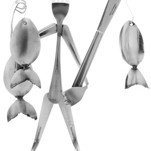 May include: A whimsical sculpture made from silverware, depicting a person holding a fishing rod with a spoon as the lure and a spoon as the fish. The sculpture is made from stainless steel.