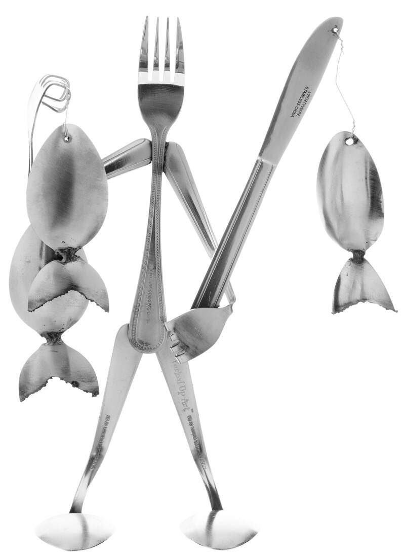 May include: A whimsical sculpture made from silverware, depicting a person holding a fishing rod with a spoon as the lure and a spoon as the fish. The sculpture is made from stainless steel.