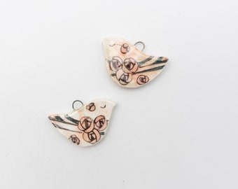 Ceramic bird pendants, hand painted on both sides, ideal for creating earrings and other jewelry.