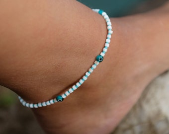 May include: White and blue beaded anklet with two turquoise evil eye charms.