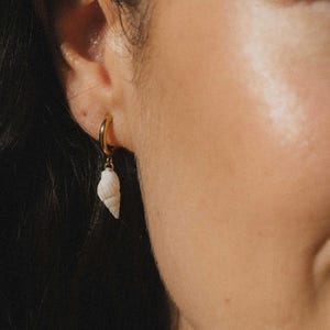 May include: A set of three ceramic vases in varying heights. The vases are white with a textured, ridged design. The tallest vase is approximately 10 inches tall, the medium vase is 8 inches, and the smallest is 6 inches.