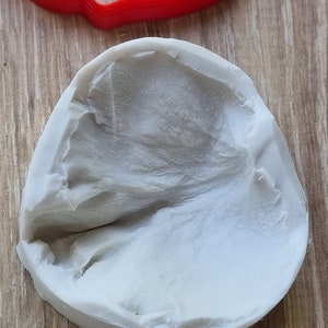May include: A white silicone mold with a textured surface. The mold is shaped like a leaf.