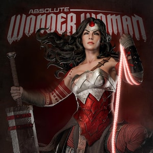 May include: A detailed image of Wonder Woman, featuring a red and silver armored bodice, a sword, and a glowing lasso. The text "ABSOLUTE WONDER WOMAN" is displayed at the top of the image.
