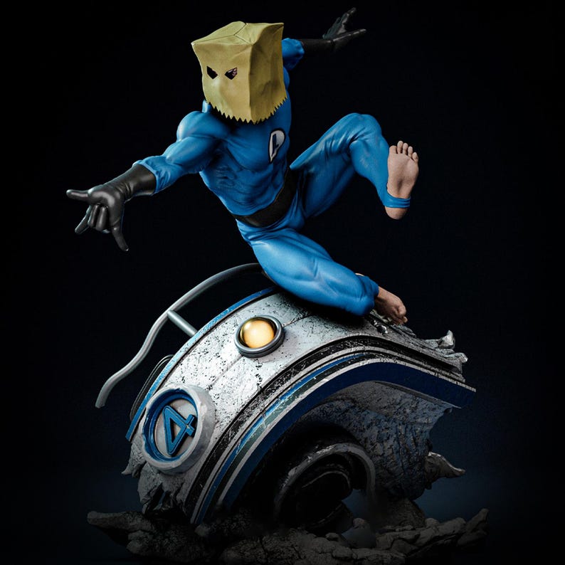 May include: A blue superhero figure with a paper bag mask, black gloves, and bare feet, posed mid-jump. The figure is atop a futuristic, metallic structure with a blue and silver design. The background is dark.
