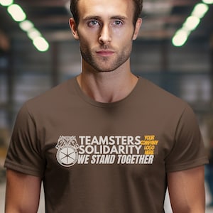 May include: A brown t-shirt with a white graphic of a gear and the text "Teamsters Solidarity We Stand Together" in orange. The text "Your Company Logo Here" is also included in white.