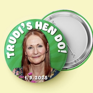 May include: A circular pin-back button featuring a photograph of a person with reddish-brown hair. The background is green with a radial pattern. The text reads "TRUDI'S HEN DO!" in white letters at the top and "1.9.2025" in white at the bottom.