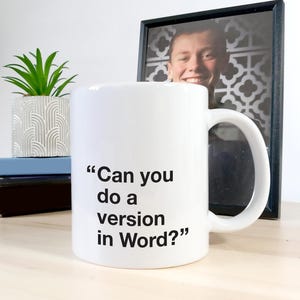 May include: White ceramic coffee mug with black text that reads "Can you do a version in Word?"