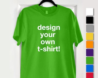 May include: A lime green t-shirt with the text "design your own t-shirt!" in white. The shirt is hanging on a black hanger against a white door. A color palette of 10 colors is shown on the right, with the text "AVAILABLE IN 10 COLOURS!" above.