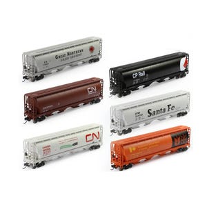 May include: A collection of model train freight cars in various colors, including gray, black, brown, white, and orange. Each car features detailed markings and logos, such as "Great Northern Grain Loading," "CP Rail," and "Santa Fe."