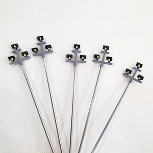 May include: A trio of ceramic mugs with a speckled, matte finish in cream, light grey, and dark grey. Each mug features a minimalist design and a rounded handle.