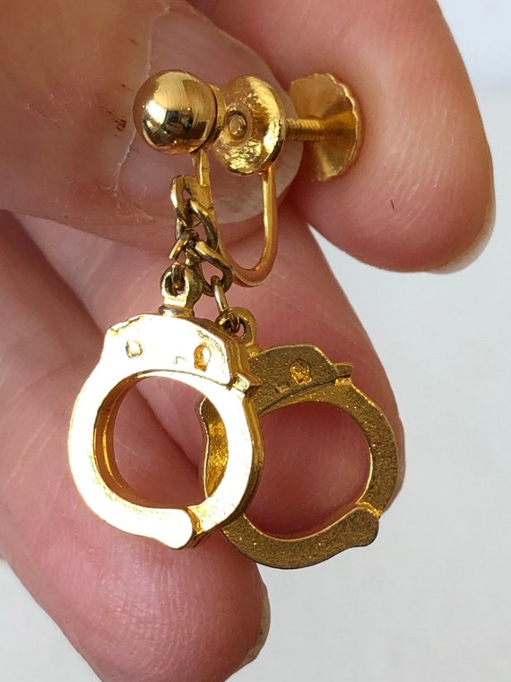 Dangling handcuff earrings store