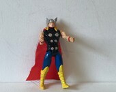 Vintage original Thor action figure with red fabric cape moveable legs and arms button in back rare collectible 90s retro Fathers Day Marvel