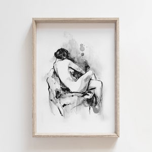 May include: Black and white ink drawing of a nude figure sitting on a rock. The drawing is framed in a light wood frame.
